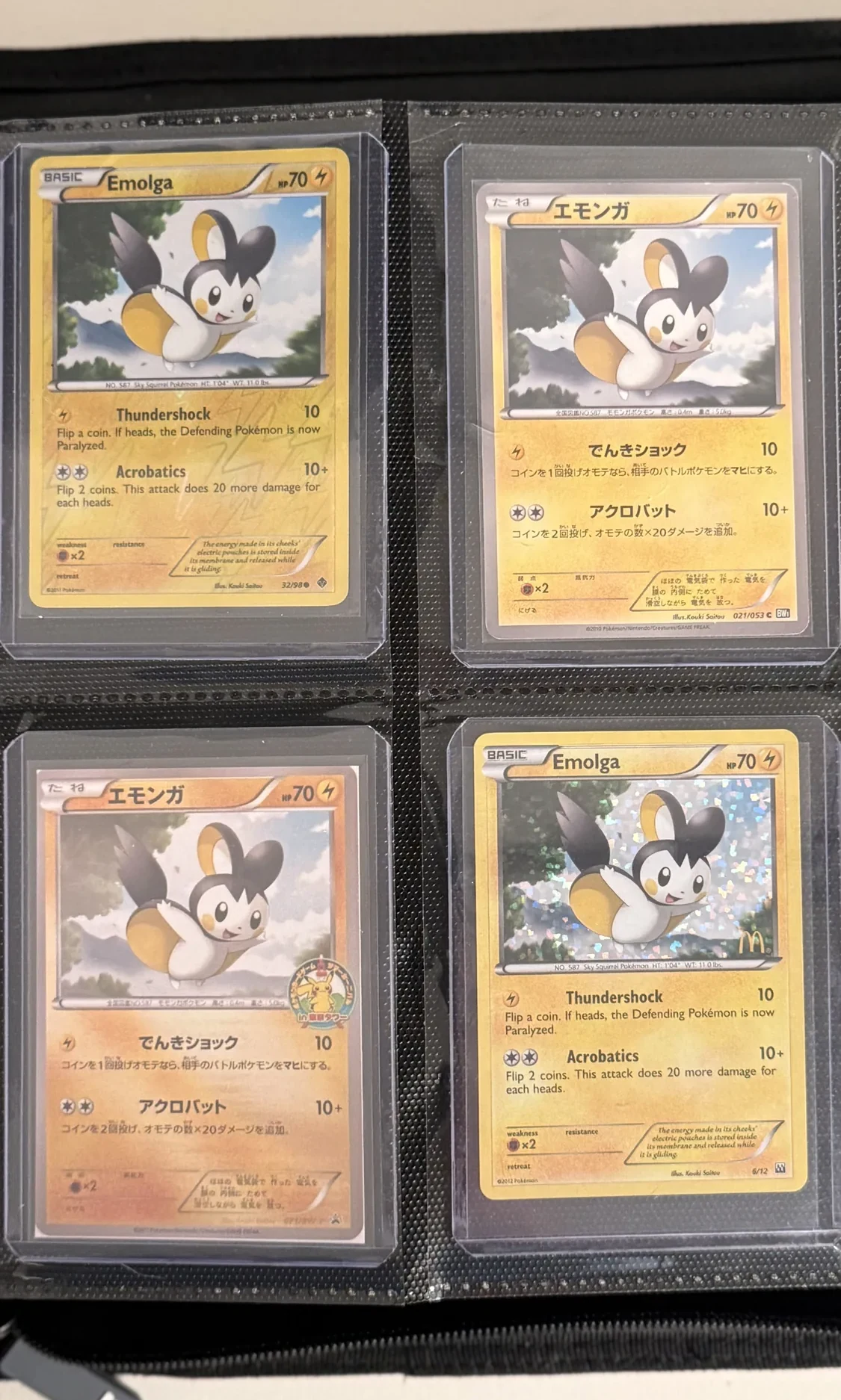 Four-pocket binder page of early Emolga cards in English and Japanese