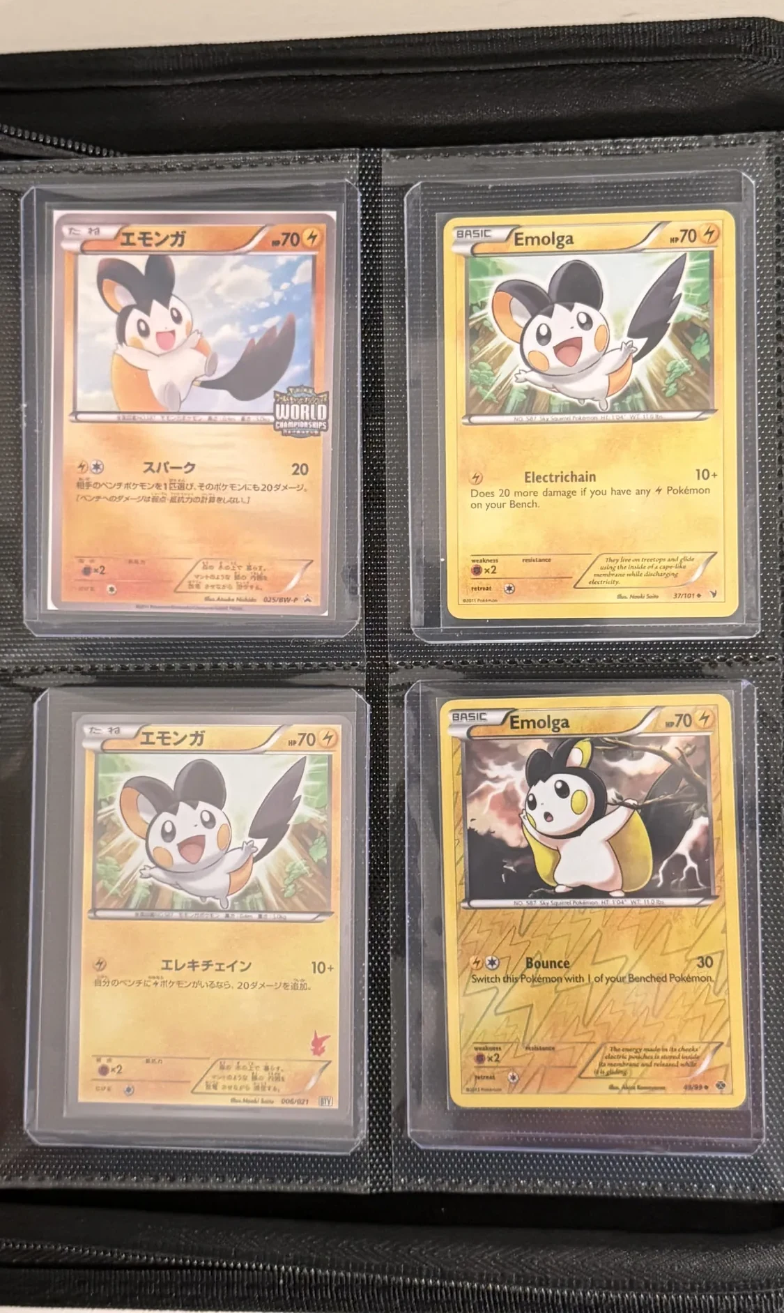 Four-pocket binder page of Emolga cards in several languages