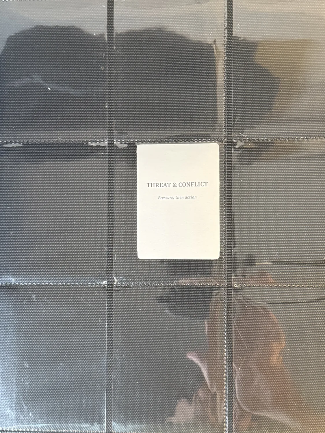 Threat and Conflict chapter divider card seated in a binder page