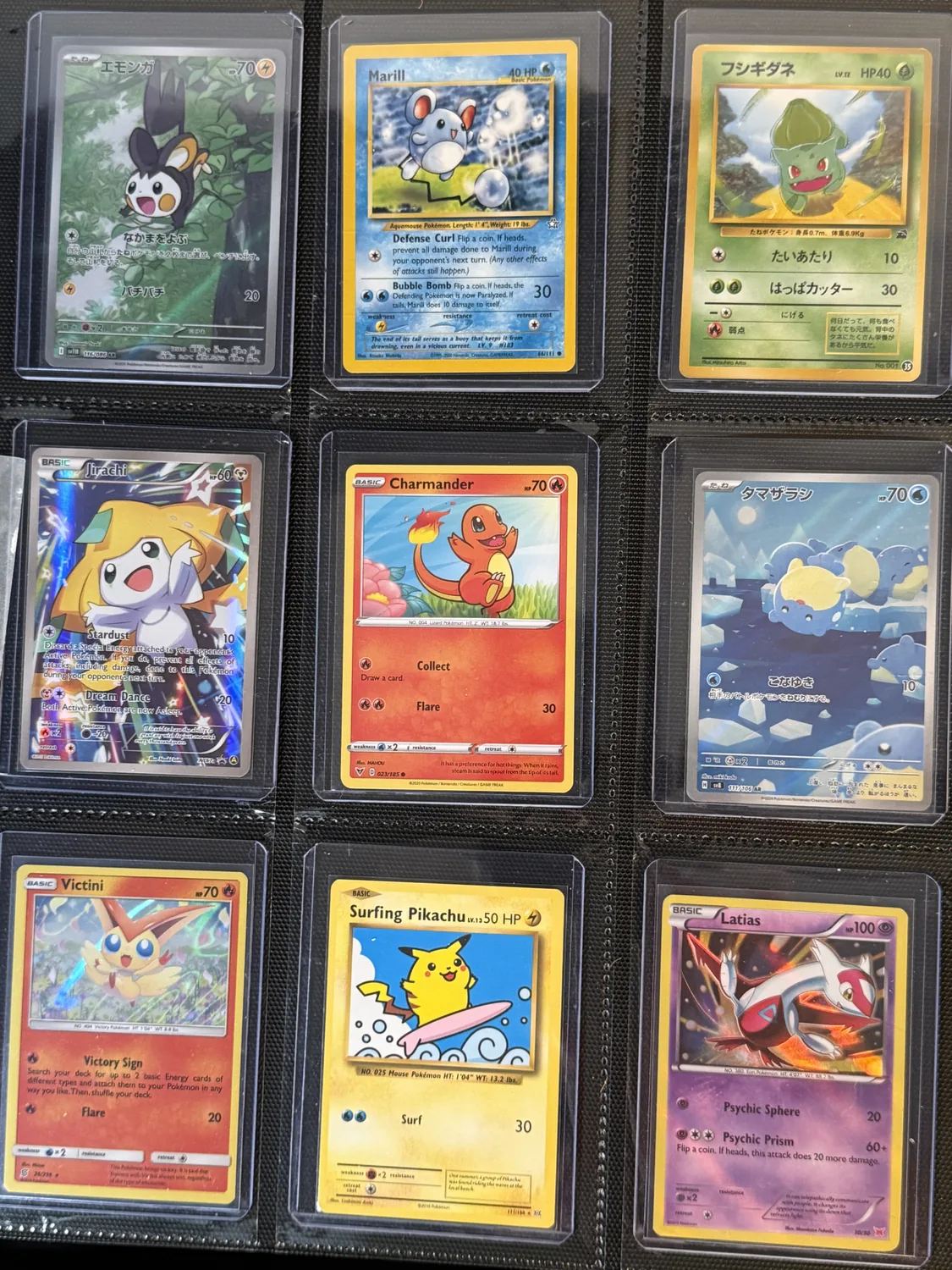 Nine-pocket binder page holding Bulbasaur, Charmander, Emolga, Jirachi, Latias, Marill, Pikachu, Spheal, Victini