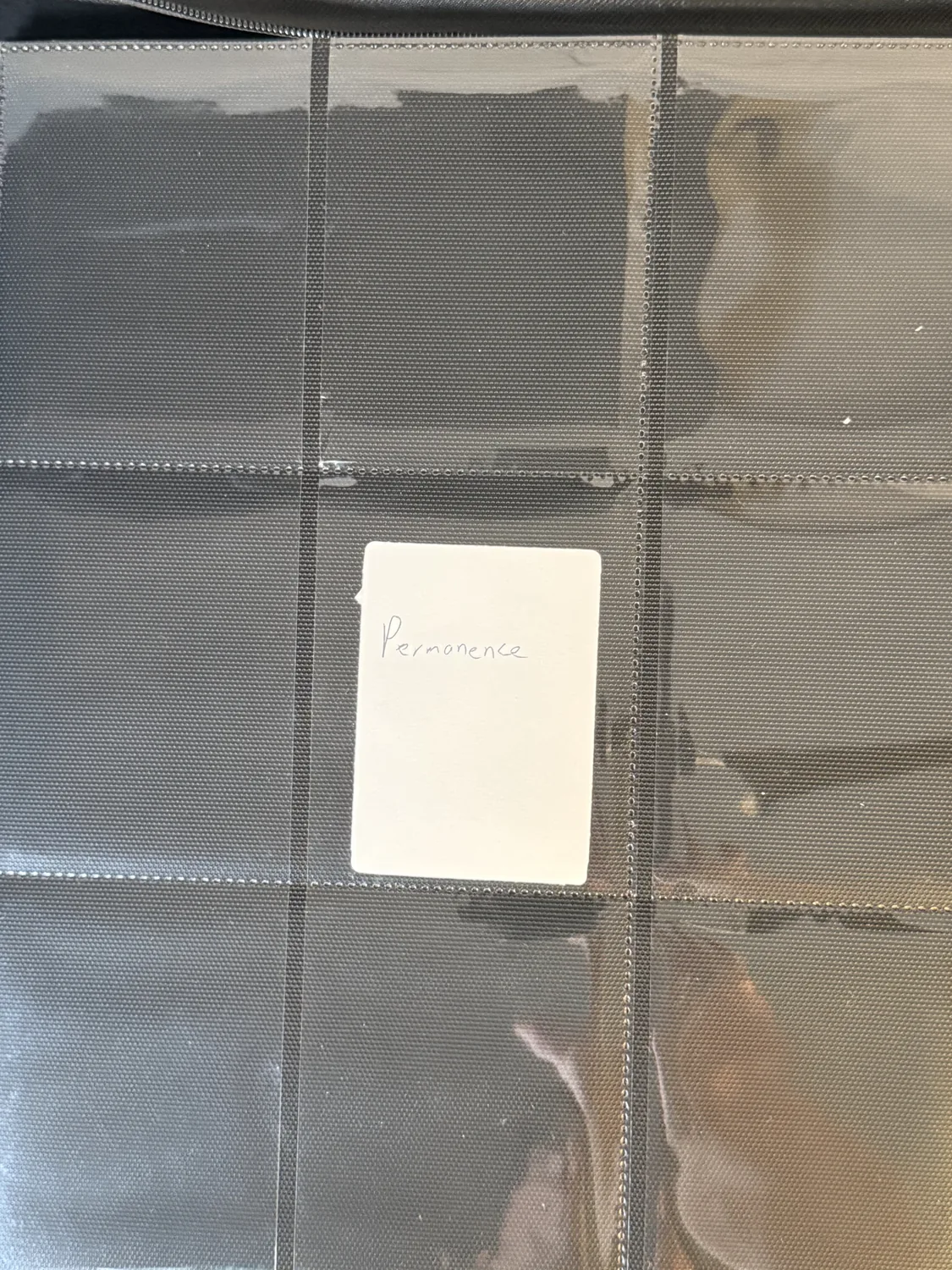 Handwritten Permanence divider card seated in a binder pocket